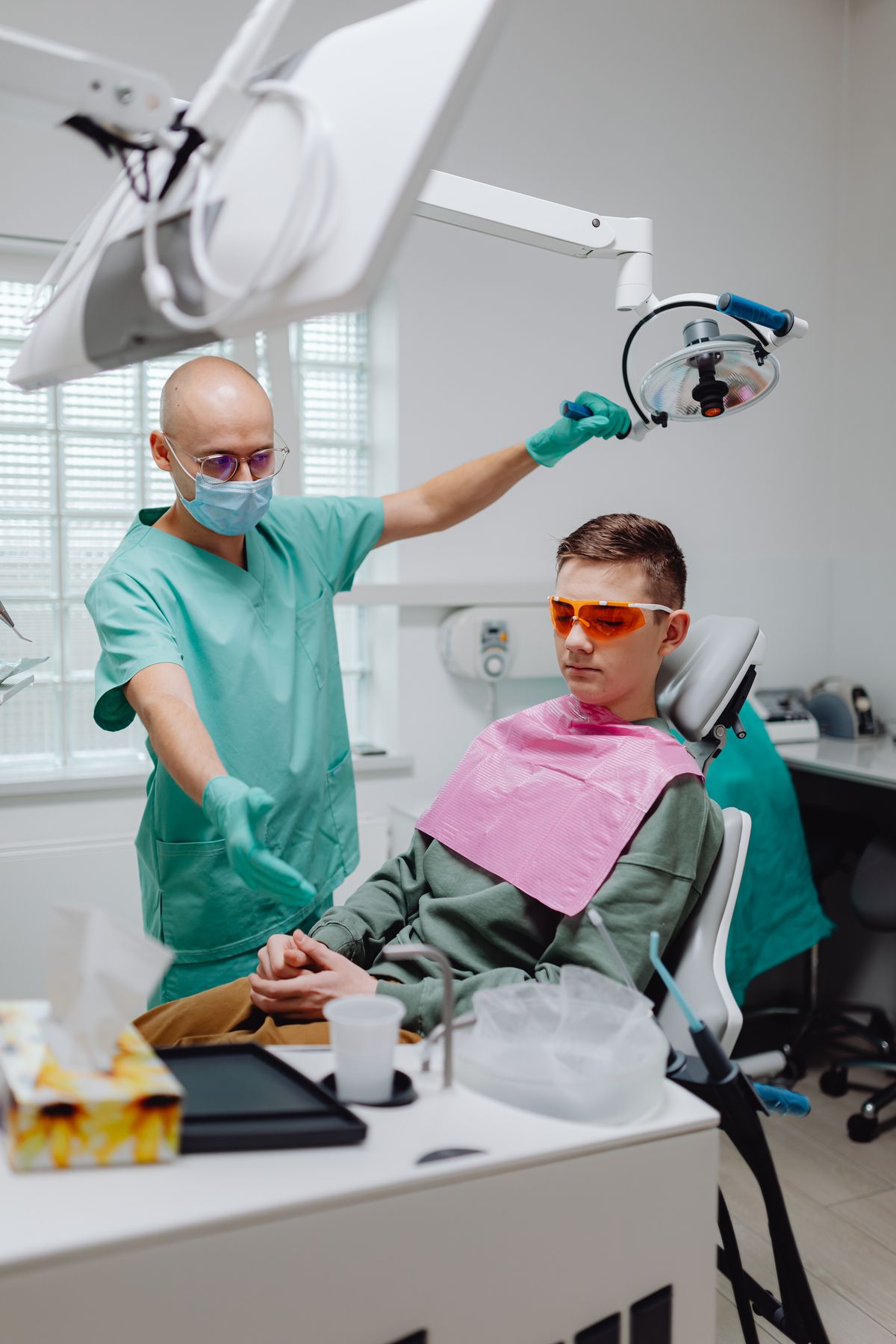 Dentist examining a patient in the dental chair