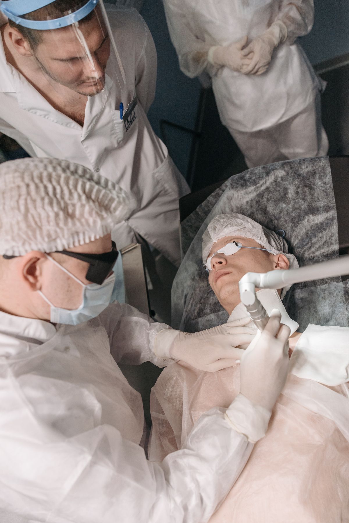Dermatologist examining a mole in a clinic setting