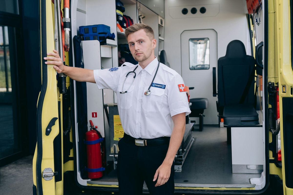 Paramedics with a stethoscope at the ambulance doors