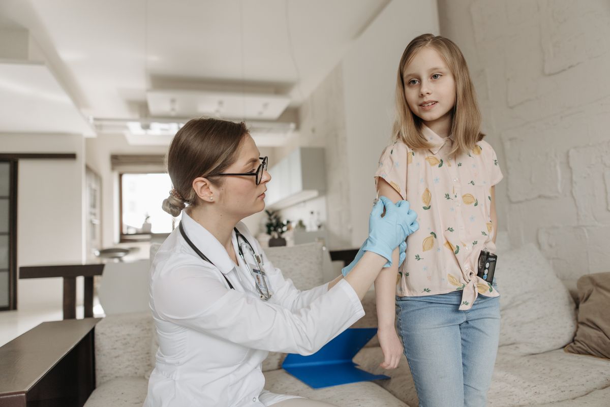 Doctor checking a child’s arm during a check-up